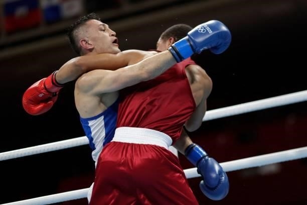 Dominican Republic's Rohan Polanco Emiliano and Uzbekistan's Bobo-Usmon Baturov fight during their men's welter preliminaries round of 16 boxing...