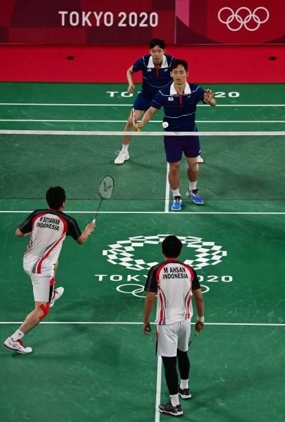 South Korea's Choi Sol-gyu looks on with South Korea's Seo Seung-jae in their men's doubles badminton group stage match against Indonesia's Mohammad...