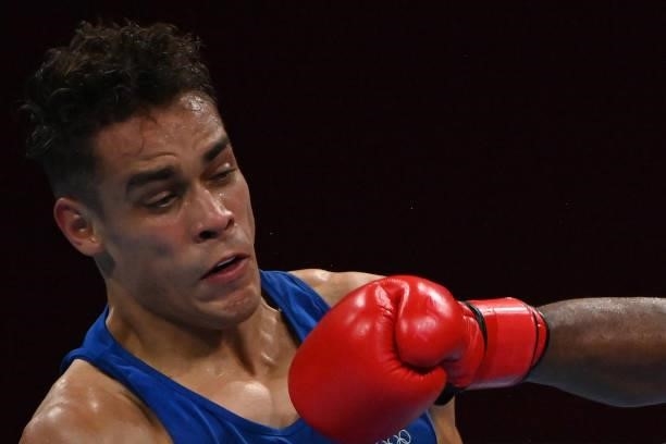 New Zealand's David Nyika takes a punch from Morocco's Youness Baalla during their men's heavy preliminaries round of 16 boxing match during the...