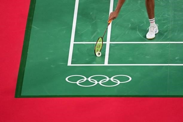 India's Chirag Shetty picks up the shuttlecock off the court in his men's doubles badminton group stage match with India's Satwiksairaj Rankireddy...