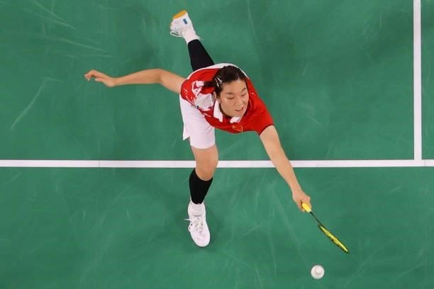 China's Jia Yifan hits a shot in her women's doubles badminton group stage match with China's Chen Qingchen against South Korea's Kim So-yeong and...