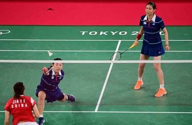 South Korea's Kim So-yeong watches as South Korea's Kong Hee-yong hits a shot in their women's doubles badminton group stage match against China's...