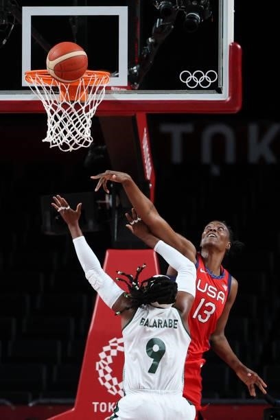 Nigeria's Aisha Mohammed goes to the basket past USA's Sylvia Fowles in the women's preliminary round group B basketball match between Nigeria and...