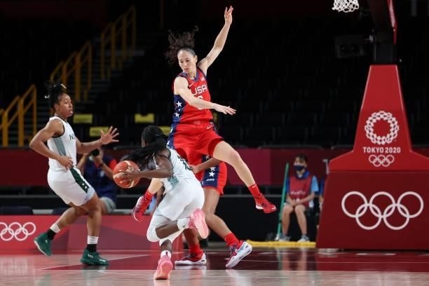 Nigeria's Promise Amukamara dribbles the ball past USA's Sue Bird in the women's preliminary round group B basketball match between Nigeria and USA...