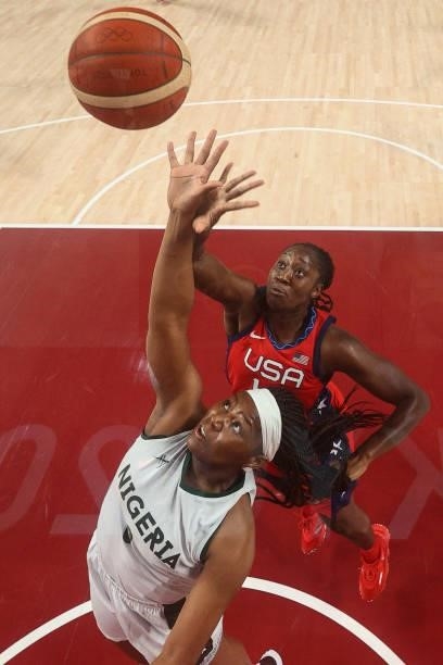 S Tina Charles jumps for a rebound with Nigeria's Amy Okonkwo in the women's preliminary round group B basketball match between Nigeria and USA...