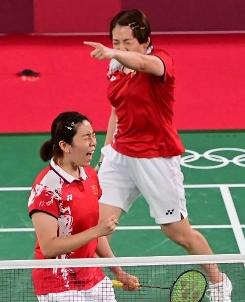 China's Chen Qingchen and China's Jia Yifan react after winning their women's doubles badminton group stage match against South Korea's Kim So-yeong...