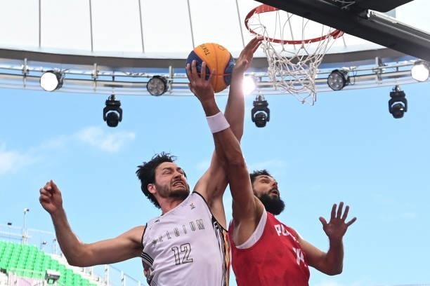 Belgium's Thierry Marien fights for the ball with Poland's Pawel Pawlowski during the men's first round 3x3 basketball match between Belgium and...