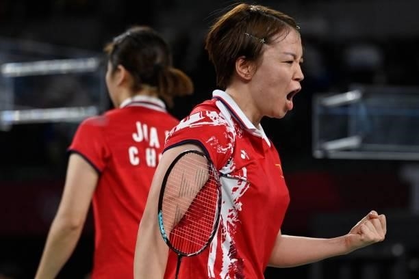 China's Chen Qingchen reacts between points in her women's doubles badminton group stage match with China's Jia Yifan against South Korea's Kim...