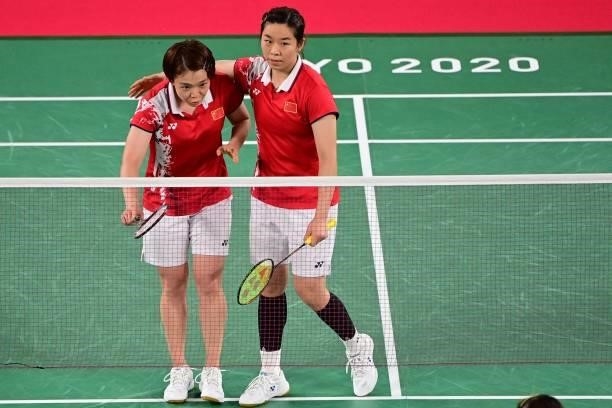 China's Chen Qingchen and China's Jia Yifan gesture to the opponents after winning their women's doubles badminton group stage match against South...