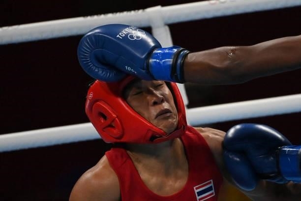 Thailand's Sudaporn Seesondee takes a punch from Ecuador's Maria Jose Palacios Espinoza during their women's light preliminaries boxing match during...