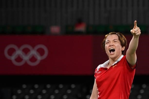 China's Chen Qingchen reacts after winning her women's doubles badminton group stage match with China's Jia Yifan against South Korea's Kim So-yeong...