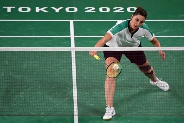 Israel's Ksenia Polikarpova hits a shot to Hong Kong's Cheung Ngan Yi in their women's singles badminton group stage match during the Tokyo 2020...