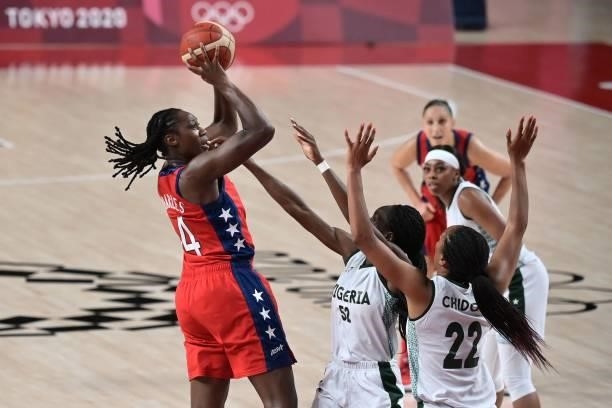 S Tina Charles shoots the ball as Nigeria's Ify Ibekwe and Oderah Chidom try to block in the women's preliminary round group B basketball match...