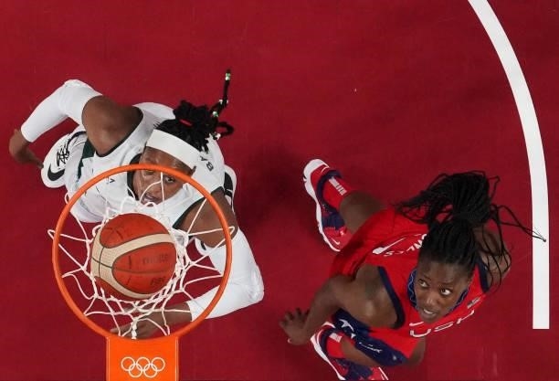 Nigeria's Aisha Mohammed and USA's Sylvia Fowles look at the basket during the women's preliminary round group B basketball match between Nigeria and...