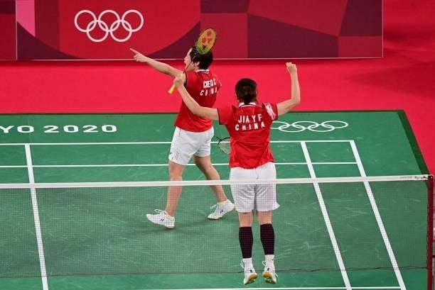 China's Chen Qingchen and China's Jia Yifan react after winning their women's doubles badminton group stage match against South Korea's Kim So-yeong...