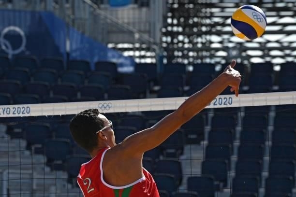 Morocco's Zouheir Elgraoui plays a shot during their men's preliminary beach volleyball pool E match between Brazil and Morocco during the Tokyo 2020...