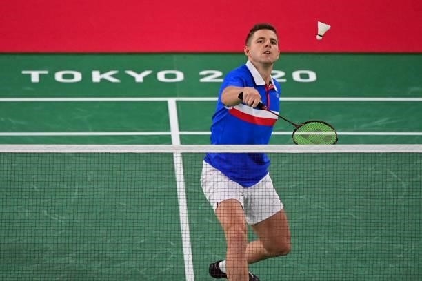 France's Brice Leverdez hits a shot to Ukraine's Artem Pochtarov in their men's singles badminton group stage match during the Tokyo 2020 Olympic...