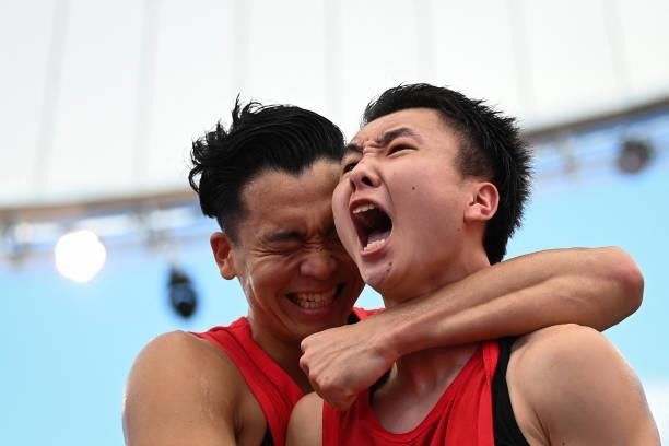Japan's Keisei Tominaga and Japan's Tomoya Ochiai celebrate after wining at the end of the men's first round 3x3 basketball match between China and...