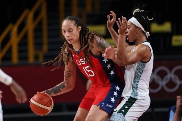 S Brittney Griner defends the ball from a Nigerian player in the women's preliminary round group B basketball match between Nigeria and USA during...