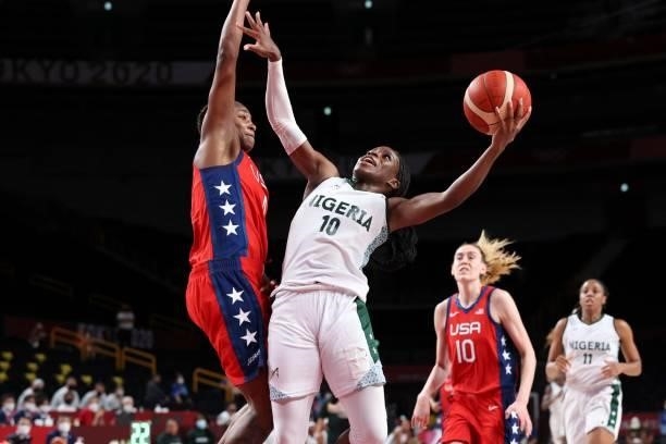 Nigeria's Promise Amukamara goes to the basket past USA's Jewell Loyd in the women's preliminary round group B basketball match between Nigeria and...