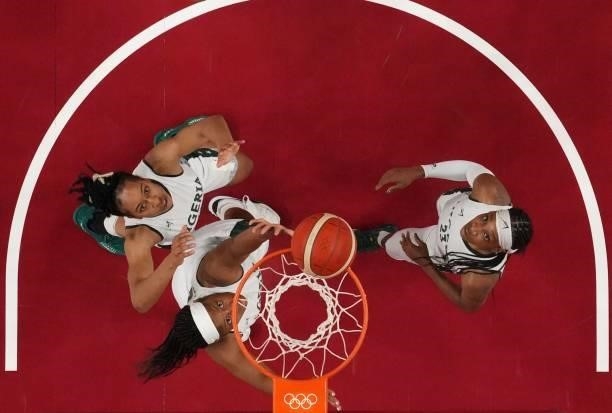 Nigeria's Ezinne Kalu looks at the basket next to teammates in the women's preliminary round group B basketball match between Nigeria and USA during...
