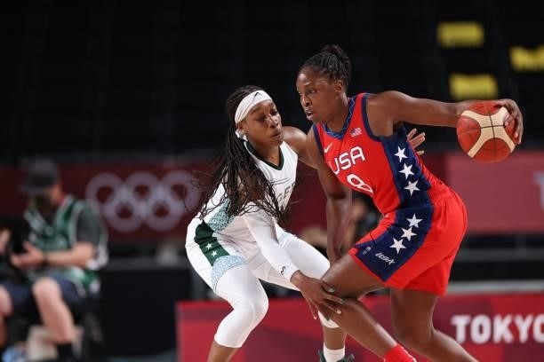 S Chelsea Gray dribbles the ball past a Nigerian player in the women's preliminary round group B basketball match between Nigeria and USA during the...
