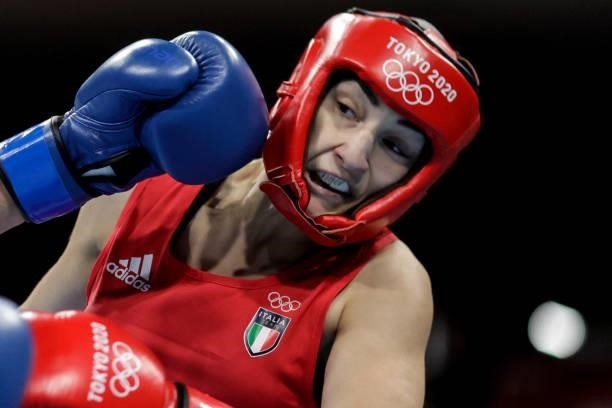 Italy's Angela Carini takes a punch from Chinese Taipei's Nien-Chin Chen during their women's welter preliminaries round of 16 boxing match during...