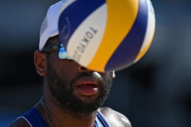 Brazil's Evandro Goncalves Oliveira Junior looks at the ball during their men's preliminary beach volleyball pool E match between Brazil and Morocco...