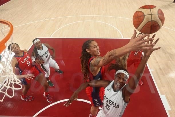 S Brittney Griner jumps for a rebound with Nigeria's Victoria Macaulay in the women's preliminary round group B basketball match between Nigeria and...
