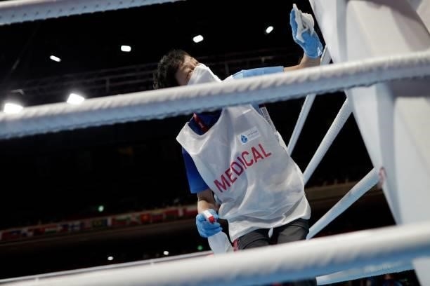Medical staff member cleans the ring during the preliminaries round of 16 boxing matches during the Tokyo 2020 Olympic Games at the Kokugikan Arena...