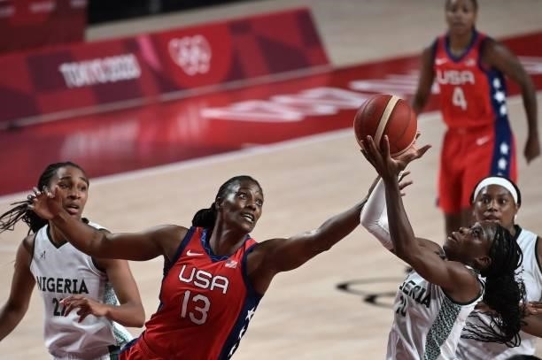 S Sylvia Fowles and Nigeria's Promise Amukamara fight for the ball in the women's preliminary round group B basketball match between Nigeria and USA...