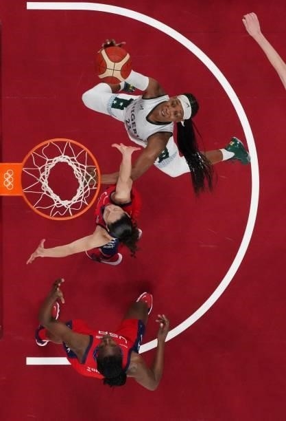 Nigeria's Ezinne Kalu past USA's Sue Bird in the women's preliminary round group B basketball match between Nigeria and USA during the Tokyo 2020...