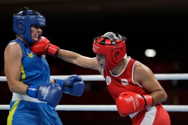 Morocco's Oumayma Bel Ahbib and Ukraine's Anna Lysenko fight during their women's welter preliminaries round of 16 boxing match during the Tokyo 2020...