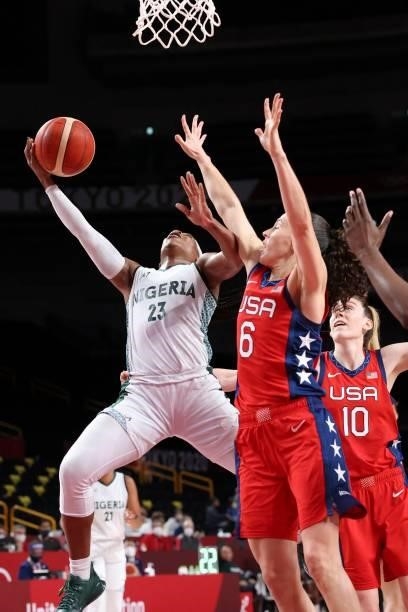 Nigeria's Ezinne Kalu goes for the basket past USA's Sue Bird in the women's preliminary round group B basketball match between Nigeria and USA...