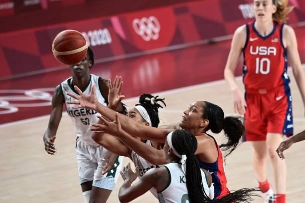 S A'ja Wilson fights for the ball with Nigerian players in the women's preliminary round group B basketball match between Nigeria and USA during the...