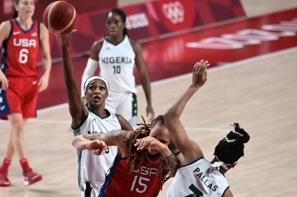 Nigeria's Victoria Macaulay shoots the ball as USA's Brittney Griner reacts in the women's preliminary round group B basketball match between Nigeria...