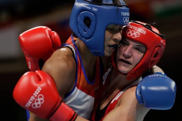 Germany's Nadine Apetz and India's Lovlina Borgohain fight during their women's welter preliminaries round of 16 boxing match during the Tokyo 2020...