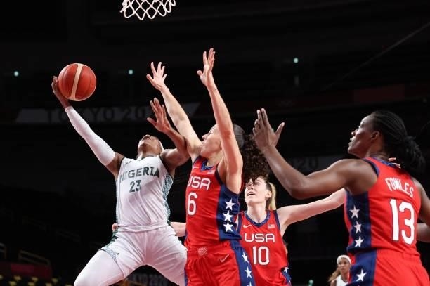 Nigeria's Ezinne Kalu goes for the basket past USA's Sue Bird in the women's preliminary round group B basketball match between Nigeria and USA...
