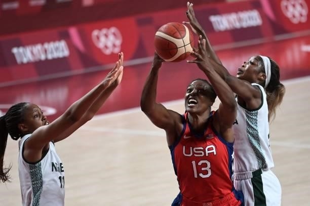 S Sylvia Fowles handles the ball as Nigeria's Adaora Elonu tries to block in the women's preliminary round group B basketball match between Nigeria...