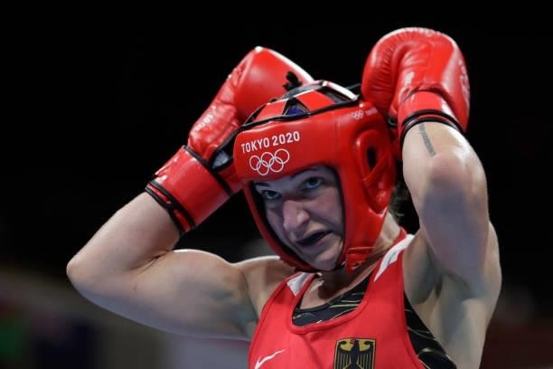Germany's Nadine Apetz reacts as he fights India's Lovlina Borgohain during their women's welter preliminaries round of 16 boxing match during the...