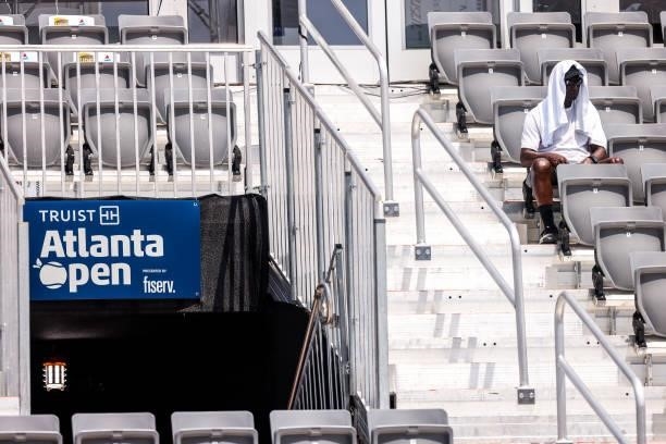 Spectator tries to keep cool while watching a match between Lloyd Harris of South Africa and Jordan Thompson of Australia at the Truist Atlanta Open...