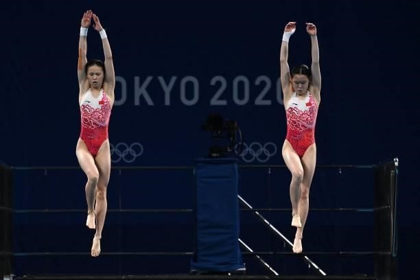 China's Zhang Jiaqi and China's Chen Yuxi compete in the women's synchronised 10m platform diving final event during the Tokyo 2020 Olympic Games at...