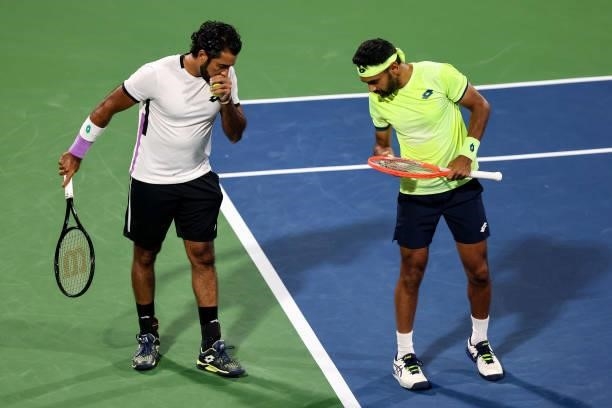 Aisam-Ul-Haq Qureshi of Pakistan and Divij Sharan of India talk together during a doubles match against Nick Kyrgios of Australia and Jack Sock of...