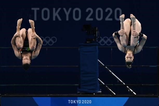 Germany's Tina Punzel and Germany's Christina Wassen compete in the women's synchronised 10m platform diving final event during the Tokyo 2020...