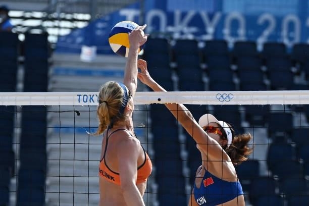 Netherlands' Madelein Meppelink vies for the ball with China's Wang Xinxin during their women's preliminary beach volleyball pool B match between the...
