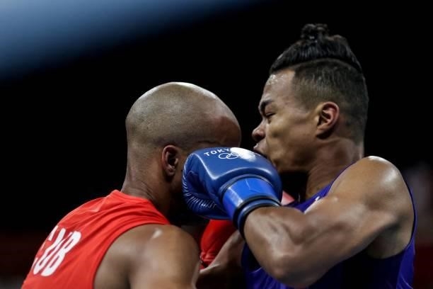Cuba's Roniel Iglesias and Japan's Sewonrets Quincy Mensah Okazawa fight during their men's welter preliminaries round of 16 boxing match during the...