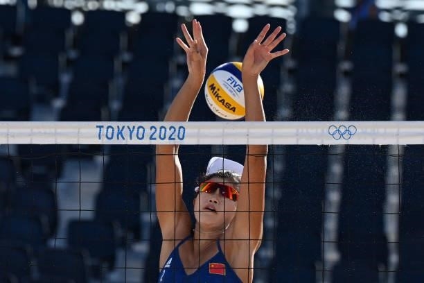 China's Wang Xinxin tries to block a shot during their women's preliminary beach volleyball pool B match between the Netherlands and China during the...