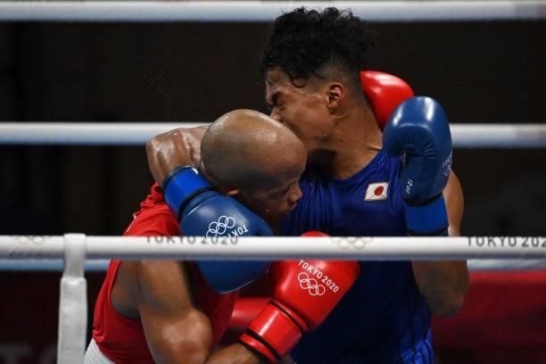 Cuba's Roniel Iglesias and Japan's Sewonrets Quincy Mensah Okazawa fight during their men's welter preliminaries round of 16 boxing match during the...