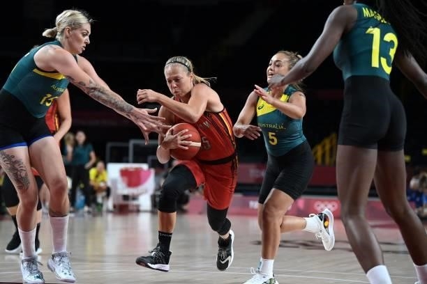 Belgium's Julie Allemand runs with the ball past Australia's Cayla George and Leilani Mitchell in the women's preliminary round group C basketball...
