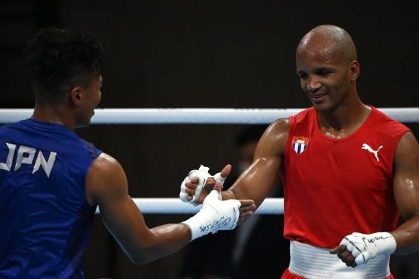 Cuba's Roniel Iglesias and Japan's Sewonrets Quincy Mensah Okazawa shake hands at the end of their men's welter preliminaries round of 16 boxing...